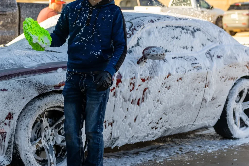Technician applying foam during a mobile detail